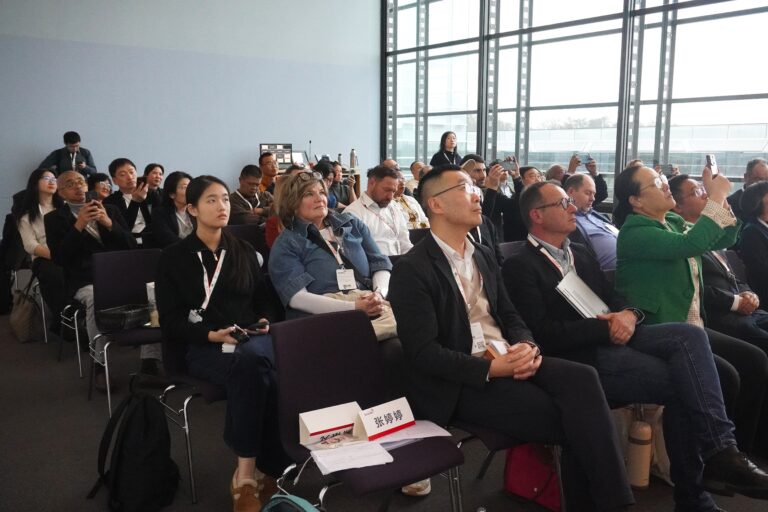 The audience follows the presentations on market opportunities in China