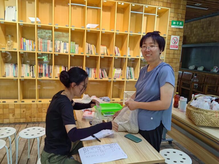 Volunteers helping to prepare seeds for storage in the community seed bank maintained by Yuefengdao Organic Farm