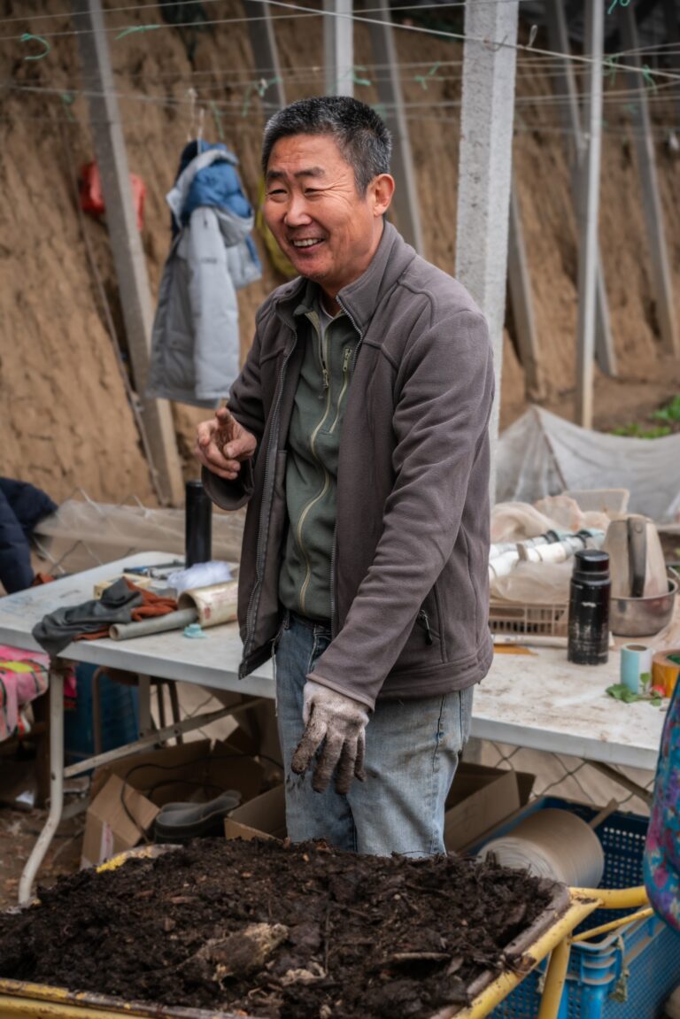 Mr. Liu explains how he makes and uses organic compost on the farm