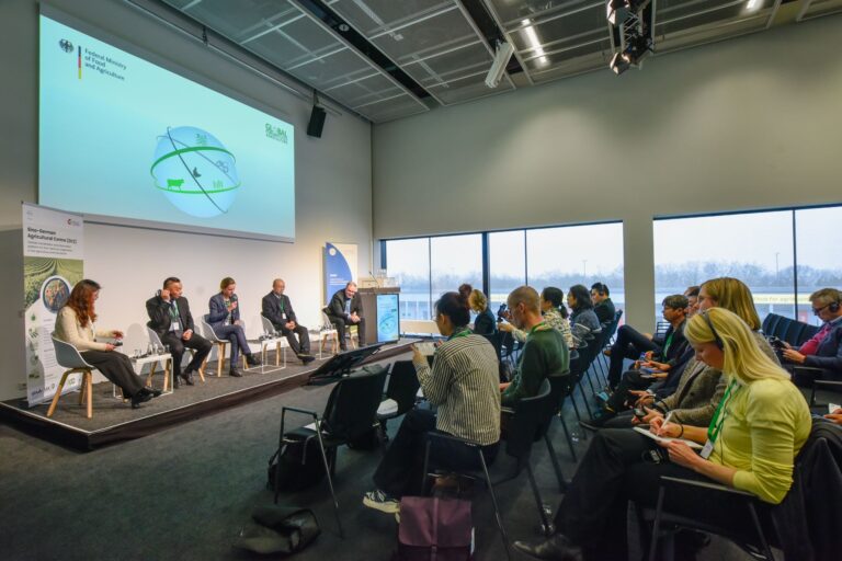 Panelists discuss with moderator Lena Kuhn (middle) from IAMO